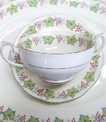 A large collection of Royal Albert dinner ware decorated with ivy leaves and red berries to