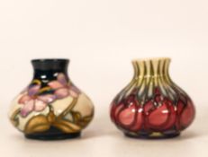 Two Moorcroft vases in the Summer Rosette and April Tulip designs. Height 5.5cm. Both boxed and