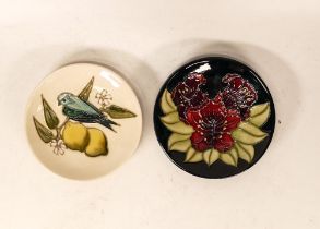 Two Moorcroft pin dishes in the finch & lemon pattern and a red floral design dated 1996. Both Boxed