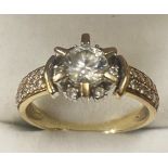 9ct yellow gold ring set with large cubic zikonia central stone surrounded by 6 smaller stones set