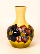 Moorcroft Clematis bud vase on yellow background , potters to the late Queen Mary sticker to base.