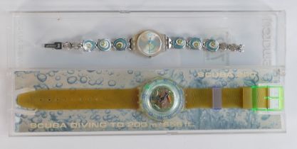 Swatch 200 scuba Divers watch in case, together with Ladies Swatch watch. (2)