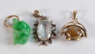 Three 9ct gold pendants including jade monkey, three stone Swivel pendant and oval clear stone