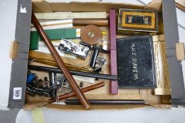 A mixed collection of items to include antique draughtsman's rules, vintage rulers, tin water colour