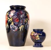 Moorcroft Anemone vase on blue together with Columbine footed vase on blue. Height of tallest21cm