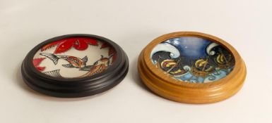 Two Moorcroft framed pin dishes in the Koi carp pattern and the other decorated with pirate boats.