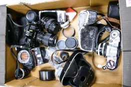 A mixed collection of vintage camera equipment to include jammed Canon A-1, Tokina Af lens, Zeiss