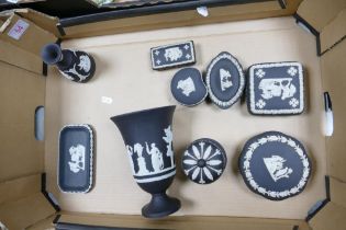 A collection of Wedgwood Black Basalt items including Urn, lidded boxes, vase , pin trays etc