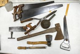 A collection of vintages tools to include files, axes, saws etc