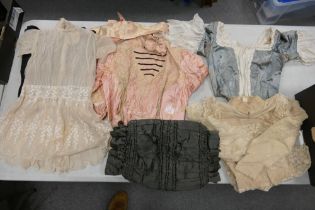 A collection of antique ladies cloths to include bodice/corset with boned straps, lace child's