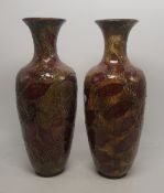 Pair of early 20th century Doulton Lambeth vases with leaf decoration, height 27cm, restoration to