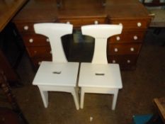 Two White Overpainted Ecclesiastic Stools with carry handles carved into the seats. Height: 81cm