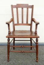 An Early 20th century Armchair. Carved pediment and back with turned supports and stretcher. Panel