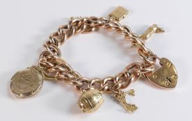 9ct rose gold hollow bracelet with 7 charms including 18ct gold ring, 40.8g.
