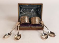 Pair of cased heavy silver napkin rings (with light initials), together with 4 odd silver tea