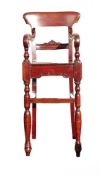 Early Victorian childs high chair. Scrolled arms echoed in front apron, back slat with Victorian