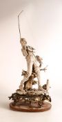 Large Bisque pottery figure of Fisherman, on gilt brass base, height including rod 60cm