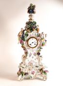 Large 19th century Meissen mantle clock on stand, modelled with woman & embracing putti, crossed