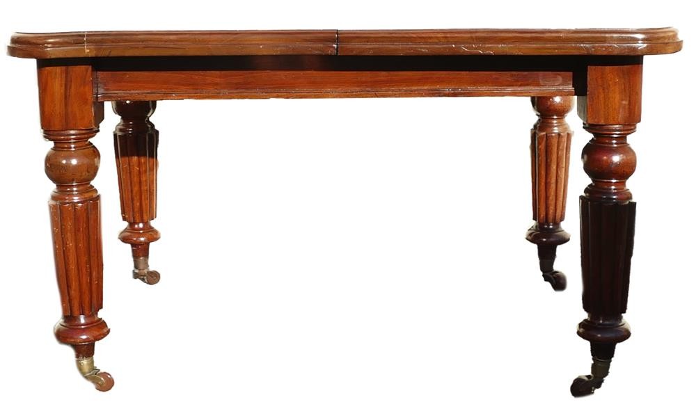 Early Victorian extending dining table on turned legs with brass fitted ceramic castors. Height: