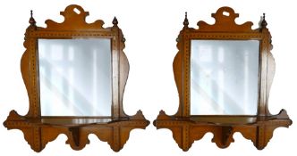 Pair of inlaid Edwardian hall mirrors with shelf, height 55cm, width 55cm, one with damaged finial.