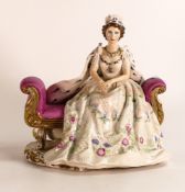 Peggy Davis figure of Her Majesty the Queen Elizabeth seated in coronation robes, unmarked but