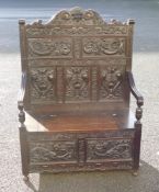 Victorian carved dark Oak hall bench with lift up lid, carved with dragons, w.100 x d.53 xh.139cm.