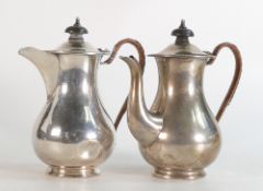 Pair of silver chocolate pots, hallmarked for Birmingham 1933, some dents to both pots. 558g.