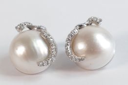 18ct white gold, diamonds and large half pearl, clip on earrings. Each earring contains 20 diamonds,
