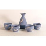 Wedgwood white on blue Jasper ware Prunus design Sake set to include decanter and four cups. From