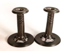 A pair of Pewter candlesticks with a pierced stand, and loose sconce made by Liberty & Co. Height