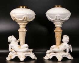 Pair of late 19th century Thomas Goode porcelain oil lamp bases, supported by two winged cherubs,