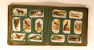 A bound collection of Ogdens , Wills , Players & similar vintage cigarette cards