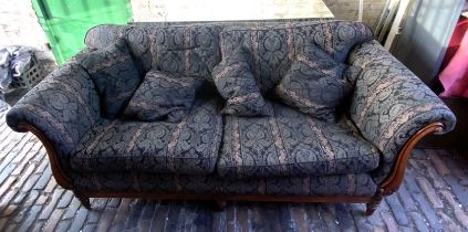 A Medallion Upholstery Ltd fabric sofa, Frame with Scrolled carved elements in Regency Style.