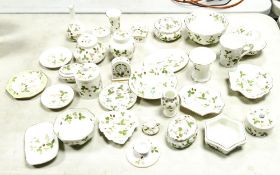 A collection of Wedgwood Wild Strawberry patterned items including vases, mantle clock, lidded pots,
