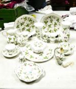 A collection of Wedgwood Wild Strawberry patterned items including plates, vases, cake stand, lidded