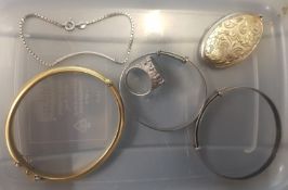A collection of silver items to include a silver gilt locket pendant, 2 silver bangles, a silver
