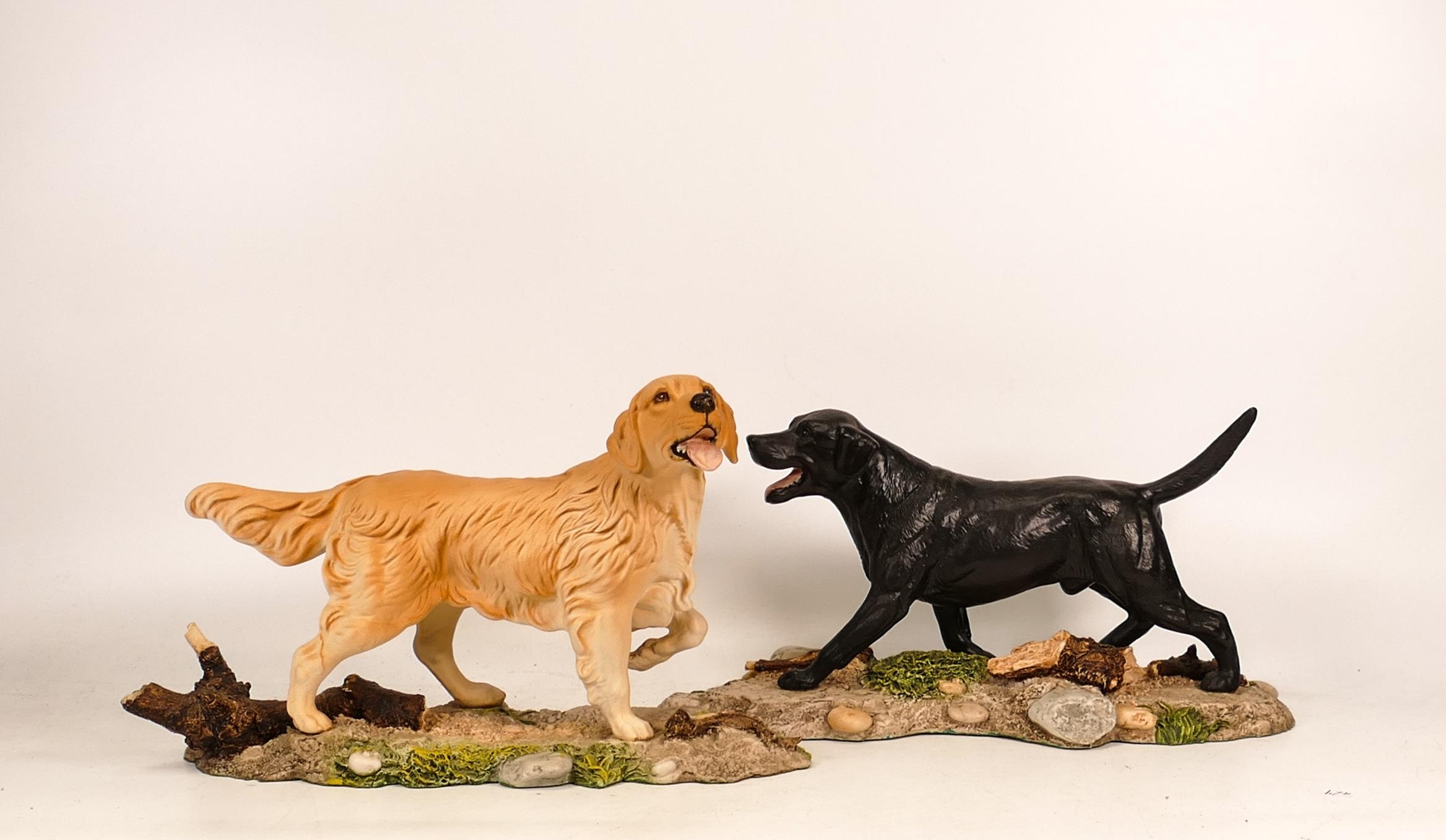 Unmarked figures of black Labrador and Golden Retriever