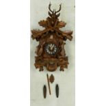 A 20th Century Chip Carved German Cuckoo Clock. Height of Clock, excl. chains and pendulum: