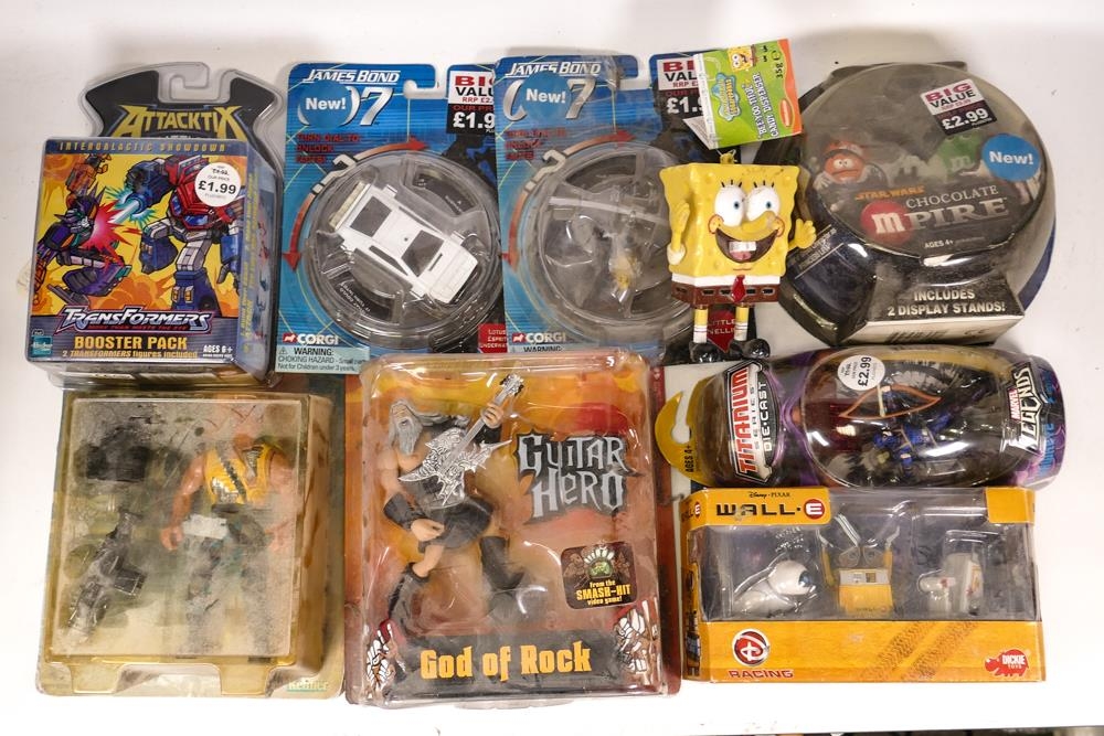 A mixed collection of Carded Figures & Vehicles including Guitar Hero God of Rock, Disney Wall E ,
