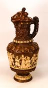 Ceramic lidded Jug with revelry scenes to body and Boar's Head to Lid - filial missing from lid -