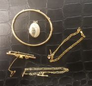 A collection of 9ct gold jewellery items, locket, bangle, brooch and bracelets, total gross weight