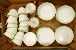 A Collection of Adderley Fine Bone China Teaware in a Green Fading and Gilt Pattern to include