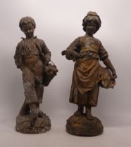 Pair of parcel gilt spelter figures of a boy and a girl, heavily tarnished, height 33cm (2).