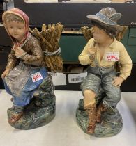 A pair of Continental figures depicting a boy and girl carrying firewood, impressed marks BU 696 &