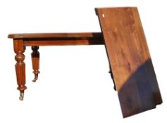 Early Victorian extending dining table on turned legs with brass fitted ceramic castors. Height: