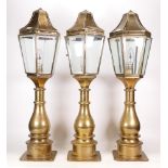 Three Matching Brass Outdoor Pillar Lamps in the style of Georgian Examples. One lamp is missing a