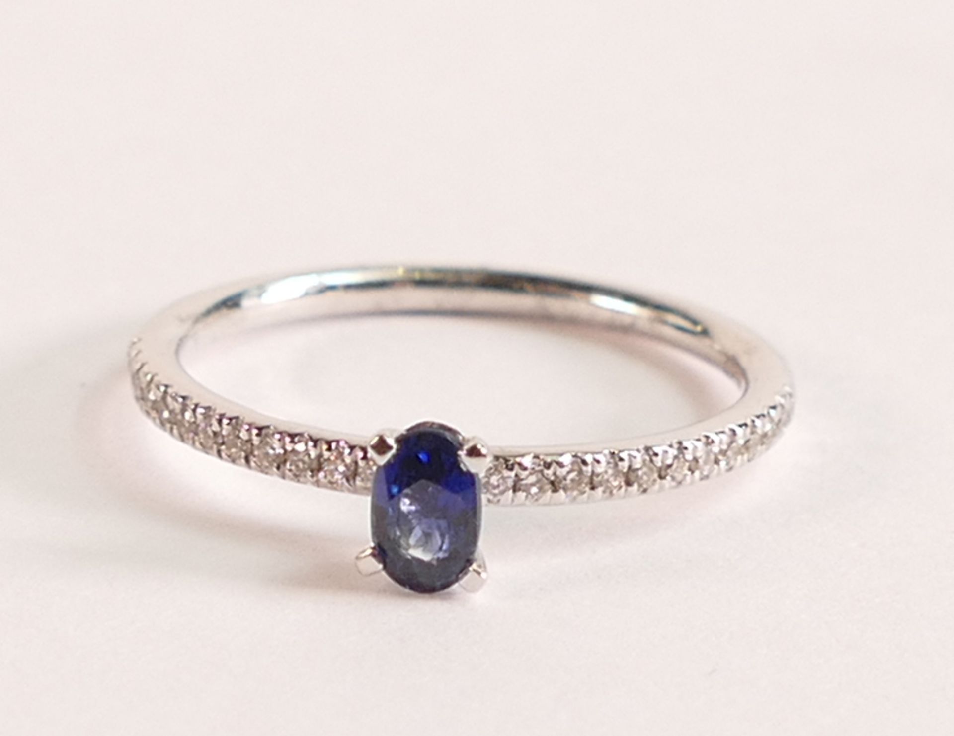 18ct White Gold Ring With Sapphire and Diamond - This elegant ring features a stunning deep blue