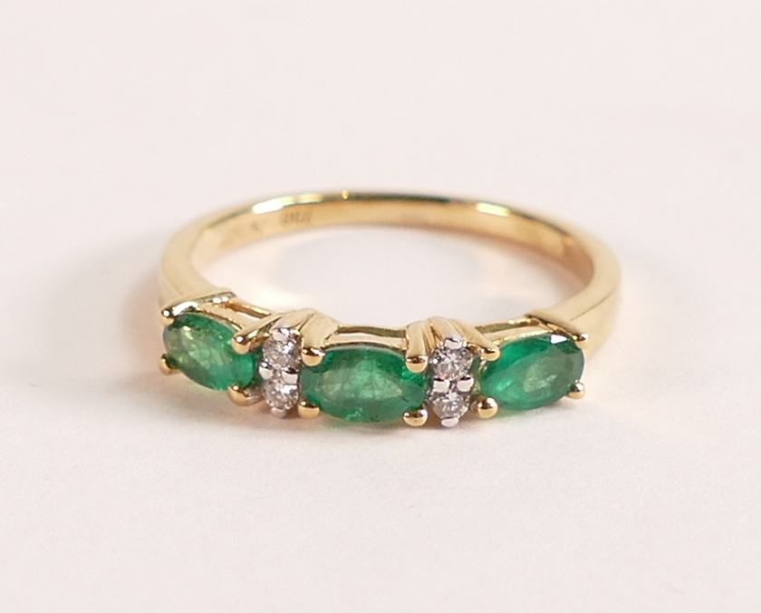 18ct Gold Ring with Marquise cut Emerald and Diamond The 18ct Gold band is stamped 750 and 18K.
