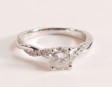 Platinum and diamond ring with diamond twist shoulders The brilliant cut Diamond measures 6mm, carat