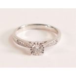 . 9ct white gold illusion set diamond ring with diamond shoulders The 9ct white gold band is stamped